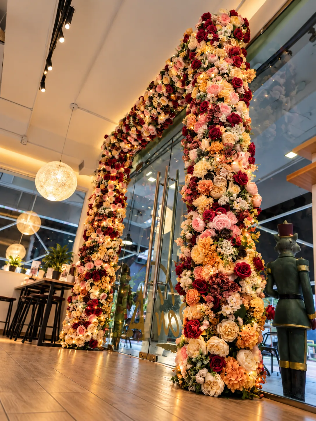 The floral arch at the entrance, lit in the evening