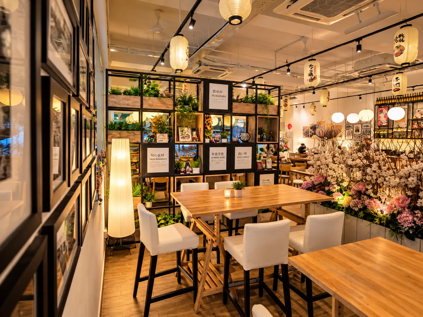 High tables by the window, framed prints and cherry blossom displays